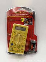Front view of sealed ToolDeal DT-830B multimeter package with included 9V battery