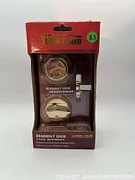 Front of sealed retail box showing brand, lock components, finish