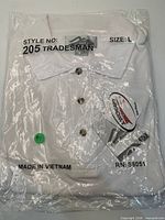 Sealed package of white Tri-Mountain 205 Tradesman polo shirt size L