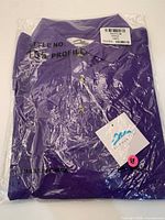 Purple Tri-Mountain Profile polo shirt sealed in poly bag with tag visible