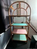 Front view of bamboo shelving unit with four colored shelves