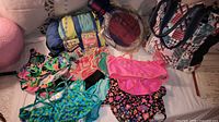All items laid out including tote, roll-up cover, rackets set, card games, swimwear pieces