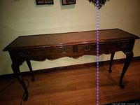 Full view of wood console table front and legs