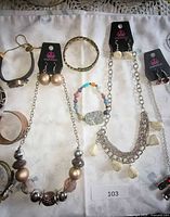 Overview of necklaces with earrings and several bracelets