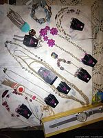 Group view of all jewelry pieces and watch