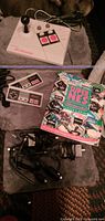 Overview showing NES Advantage joystick, two NES controllers, RF unit, RF switch, MIDI cable, and game guide