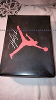 Black Jordan Flight shoe box lid with red Jumpman logo