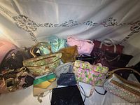All 16 bags arranged side-by-side showing variety of colours and sizes