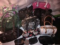 Group shot of all handbags, totes, laptop bag and small accessories