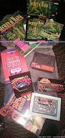Mixed view of Secret of Mana boxes, Super Metroid items, Game Genie book and cartridge