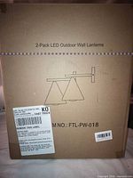 Front of sealed box labeled 2-Pack LED Outdoor Wall Lanterns model FTL-PW-018