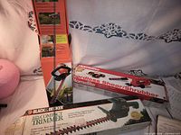 All three boxed yard tools displayed together