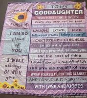 Full view of fleece blanket with printed message and sunflower design
