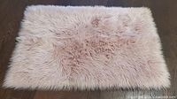 Top view of pink faux fur rug showing full surface and color