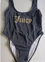 Front view of black one-piece swimsuit showing gold Juicy logo