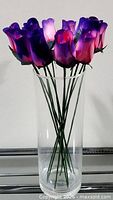 Twelve wooden roses displayed in clear vase