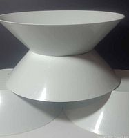 Stacked white plastic bowls showing shape and color