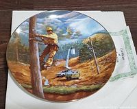 Front of decorative plate showing lineman scene