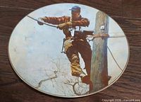 Front view of porcelain plate showing Rockwell artwork and gold rim