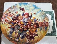 Front artwork of the plate with children celebrating baseball victory