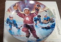 Front of decorative plate showing artwork and signature