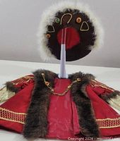 Cloak front and matching hat displayed