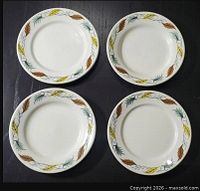 Four matching side plates displayed top view