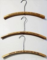 All three hangers aligned to show printed advertising text