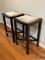 Full view of both bar stools showing upholstery and frame