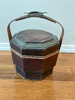 Full view of octagonal Chinese lunch/wedding box with handle raised