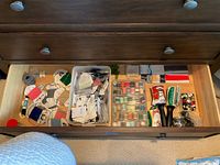 Drawer overview showing buttons bin, thread tray, mending yarn cards, yarn ball, tools and swatches