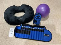 All items together: donut pillow, purple ball, rolled and unrolled ankle weights with metal inserts visible