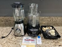 Cuisinart food processor, Anthter blender, accessories tray, manuals visible