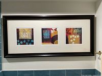 Full view of framed trio artwork on wall
