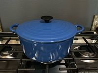 Blue Le Creuset Dutch oven with lid on stovetop