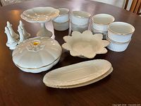 Group shot of all Lenox porcelain pieces and Golden Heirloom ramekins displayed on table
