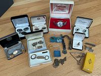 Overview of watch, boxed cufflink sets, and loose accessories