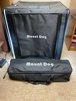 Front view of assembled lightbox with zip panel closed and carrying bag in front