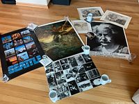 Overview of all posters and prints laid flat with weights