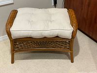 Front view of rattan wicker footstool with cushion