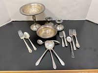 Group shot of all sterling pieces on black background