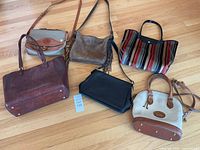 Overview of all six handbags laid out on floor