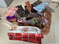 Overview of all scarves spread on carpet