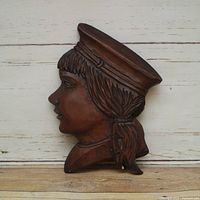 Front view showing carved profile and overall condition