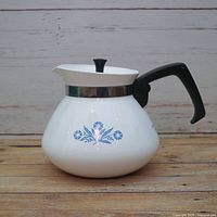 Left profile of coffee pot showing pattern, handle, lid