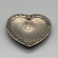 Top view of heart-shaped dish showing floral border and tarnish