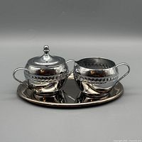 Full view of sugar bowl, creamer and tray set