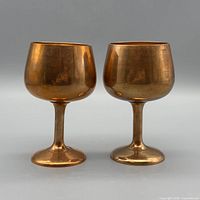 Front view of both brass goblets showing shape and finish