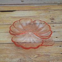 Top view of pink depression glass dish showing three compartments