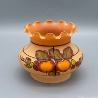 Front view showing ruffled rim, fruit painting and color gradient